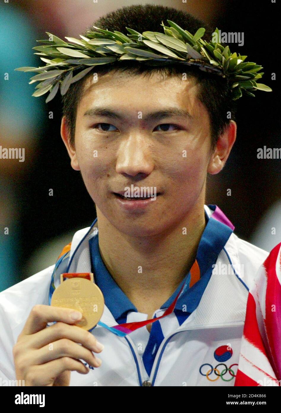 South Korea's Ryu Seung min displays his gold medal for the men's singles table tennis at the Athens 2004 Olympic Summer Games August 23, 2004. [Ryu won the gold ahead of China's Wang Hao and China's Wang Liqin.] Stock Photo