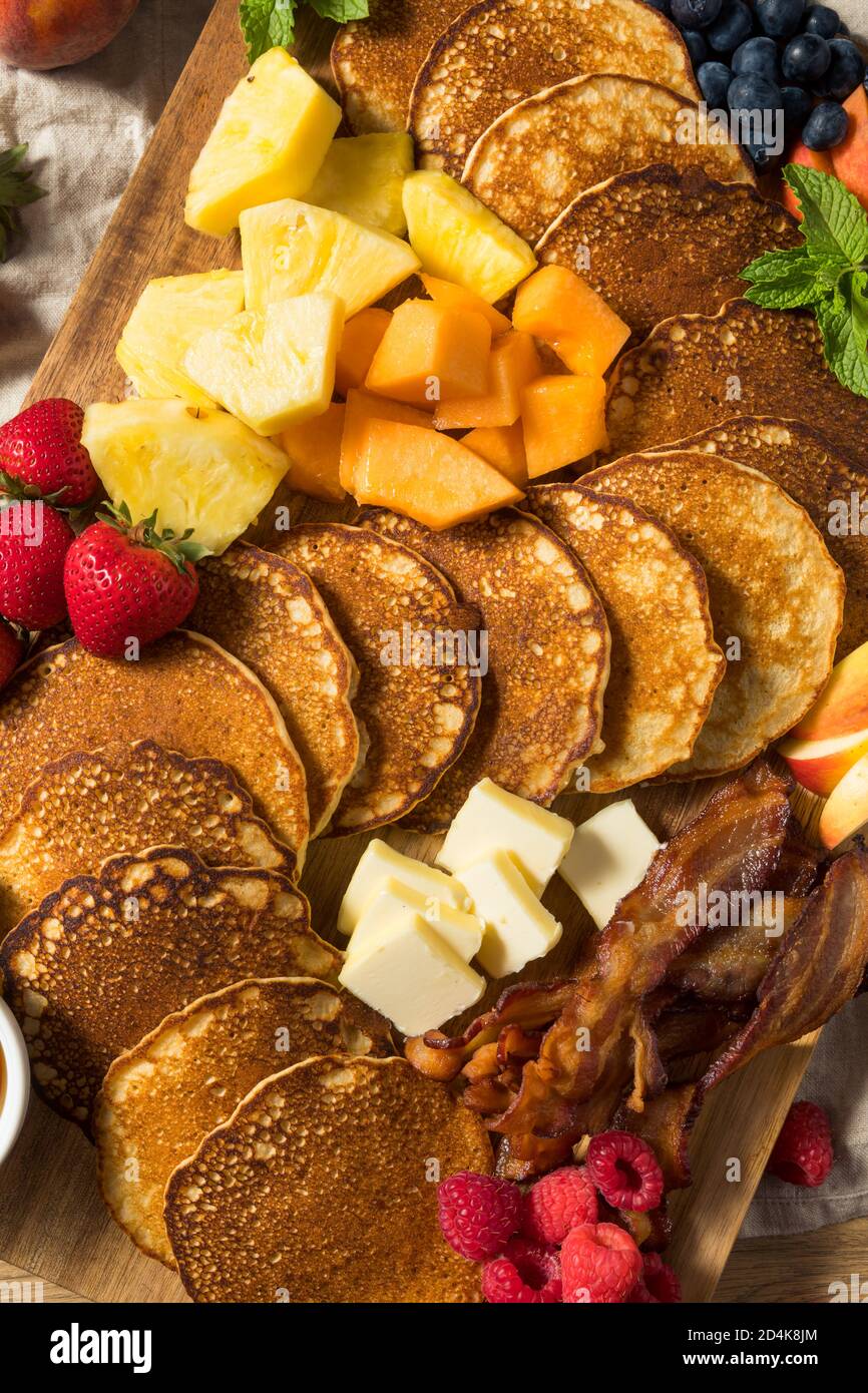 Homemade Pancake Charcuterie Board with Fruit and Bacon Stock Photo