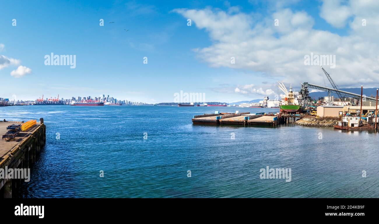 Panoramic view downtown Vancouver. From North Vancouver, by Second Narrows Bridge / Iron Workers Bridge. Port industry foreground. Background: City sk Stock Photo