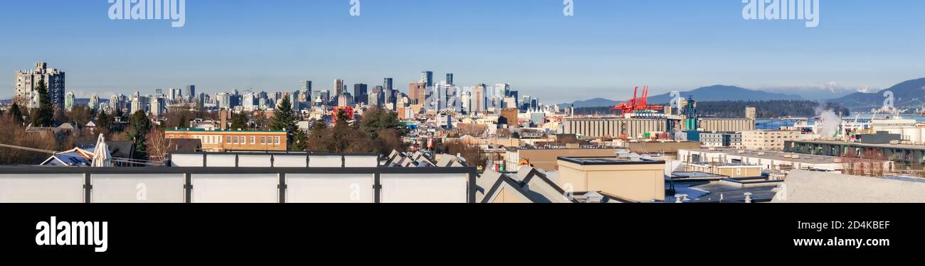 Downtown Vancouver panorama from Vancouver rooftop apartment, British Columbia, Canada. Sunny day with blue sky. Modern downtown high-rise building mi Stock Photo