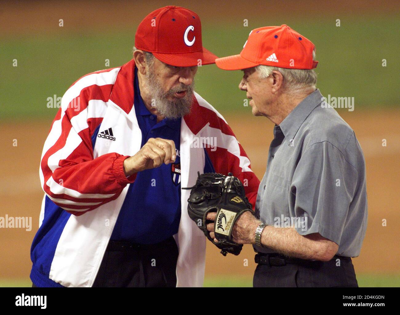 Cuban President Fidel Castro (L) and Former U.S. President Jimmy Carter  wear baseball hats and gloves at a baseball stadium in Havana, in this May  14, 2002 file photo. Castro has given