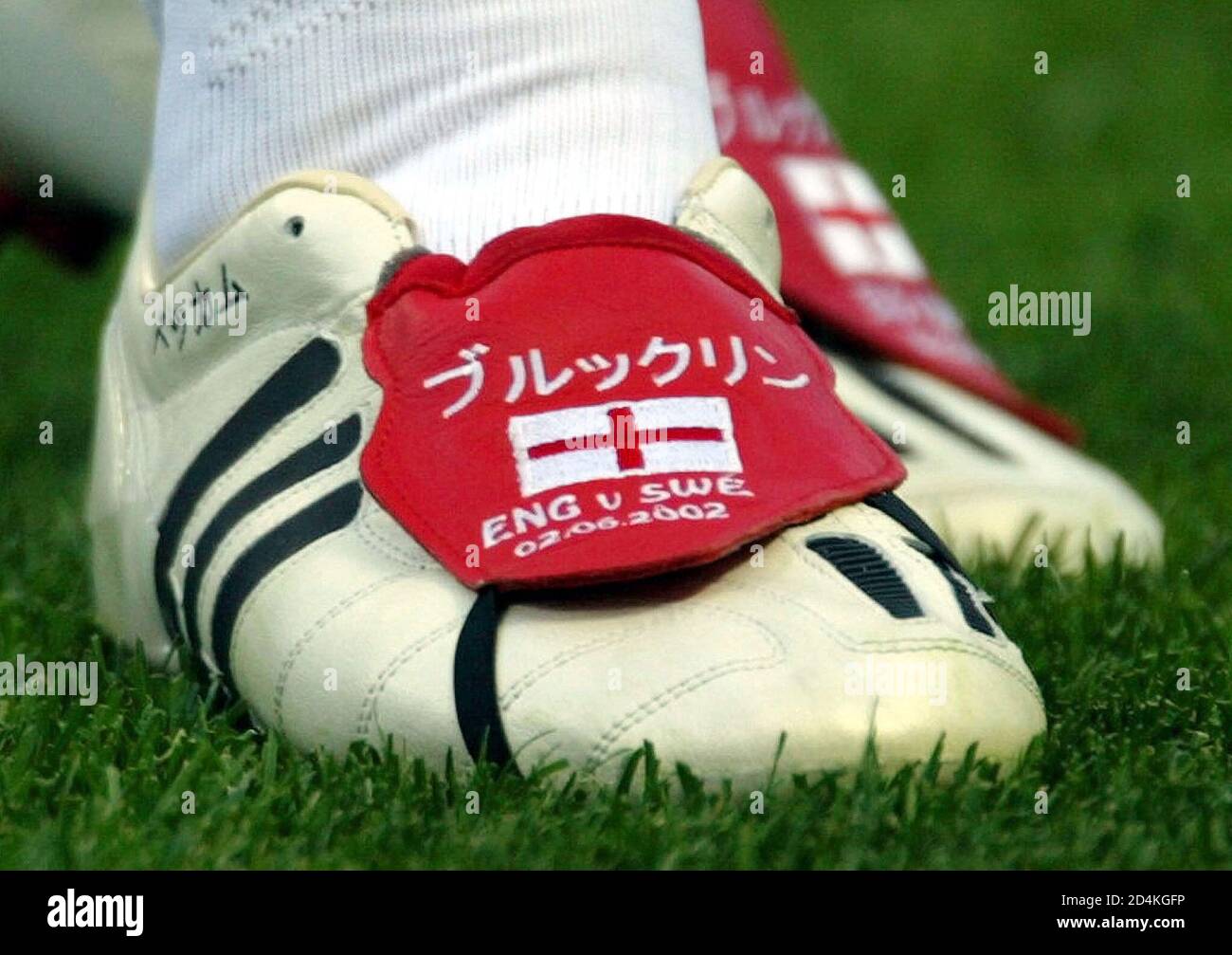 England captain David Beckham wears a pair of custom made boots for the  match with [Sweden] in the World Cup Finals group F in Saitama June 2,  2002. [At left is the