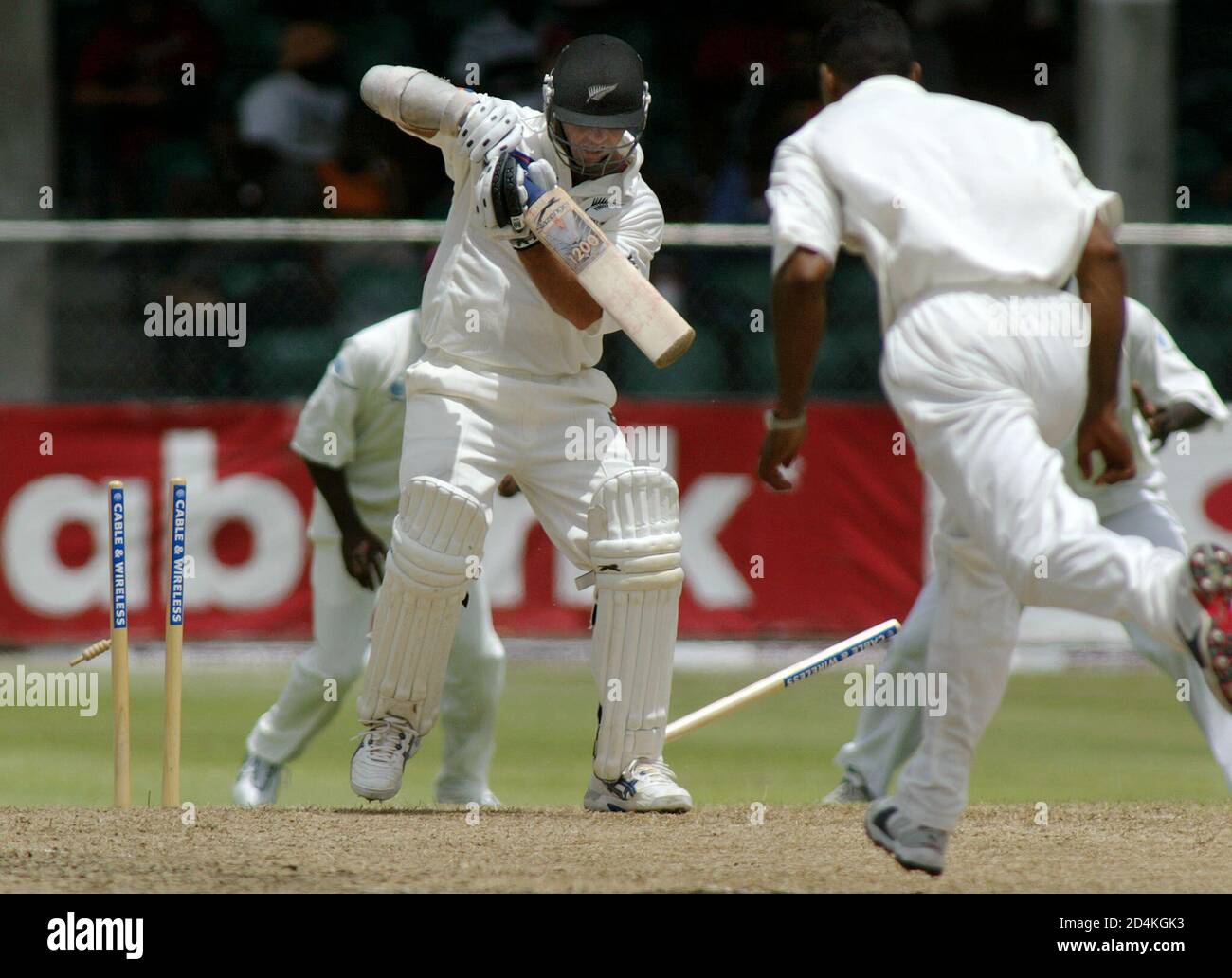 New Zealand batsman Mark Richardson is bowled out by West Indies' Adam  Sanford (R) during the first day of play in the first test in Bridgetown,  Barbados, June 21, 2002. Richardson was