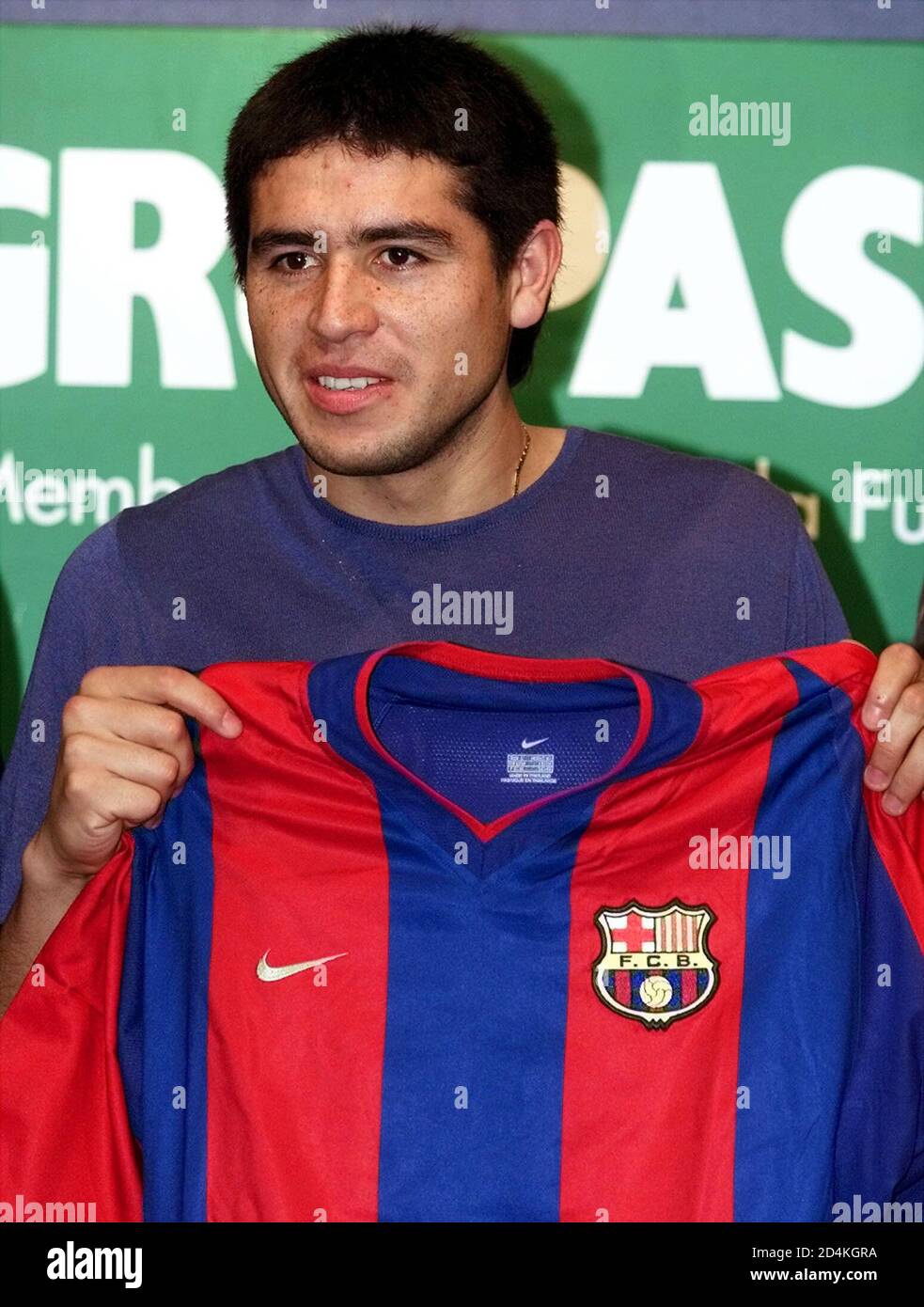 Argentinian soccer midfielder Juan Roman Riquelme shows his new FC Barcelona  shirt before at a press conference at Barcelona Nou Camp stadium July 15,  2002. Riquelme signed a contract with Barcelona for