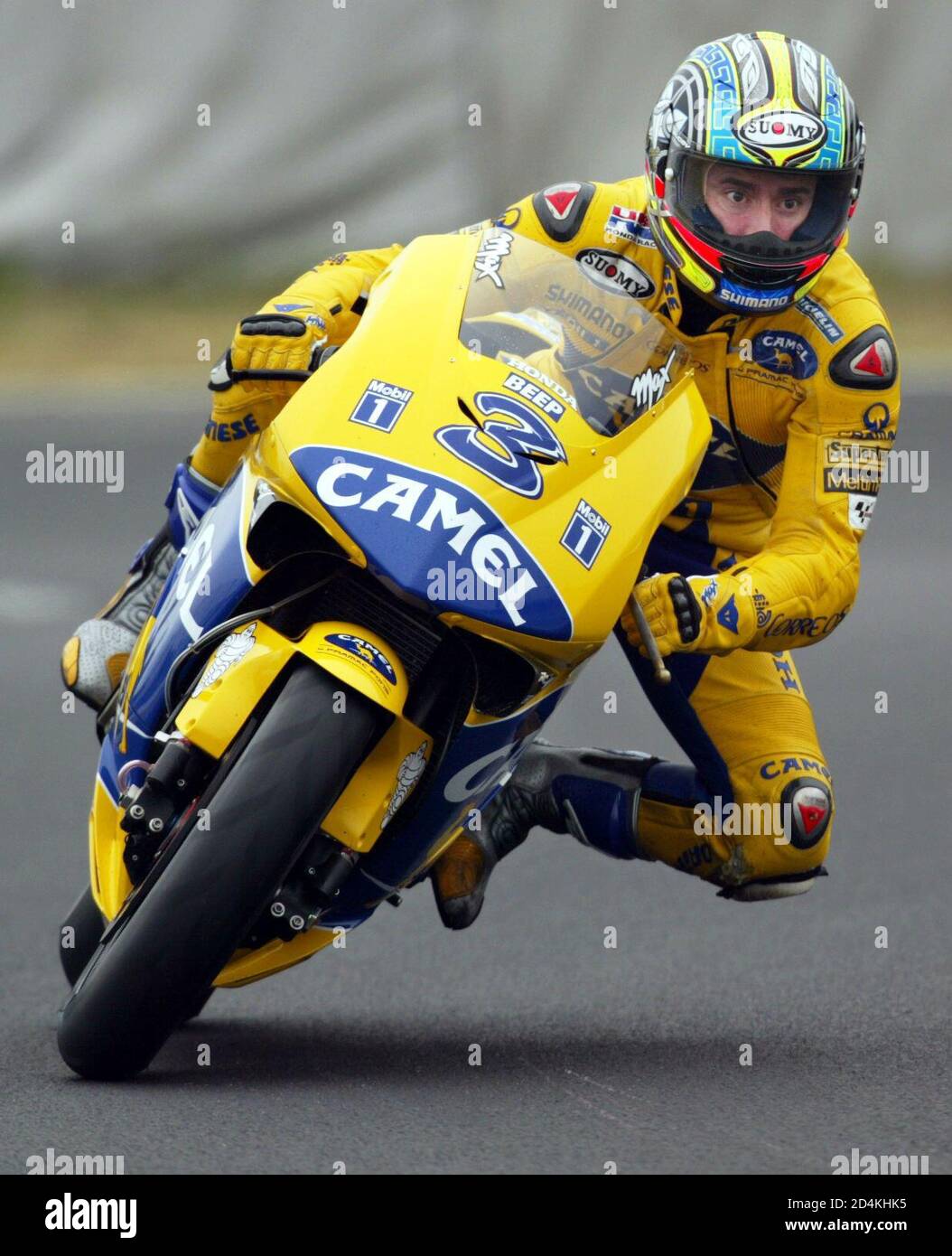 Italy's Max Biaggi steers his Honda on the Suzuka Circuit track in a  qualifying practice of the MotoGP Grand Prix of Japan in Suzuka, central  Japan April 4, 2003. Biaggi clocked the