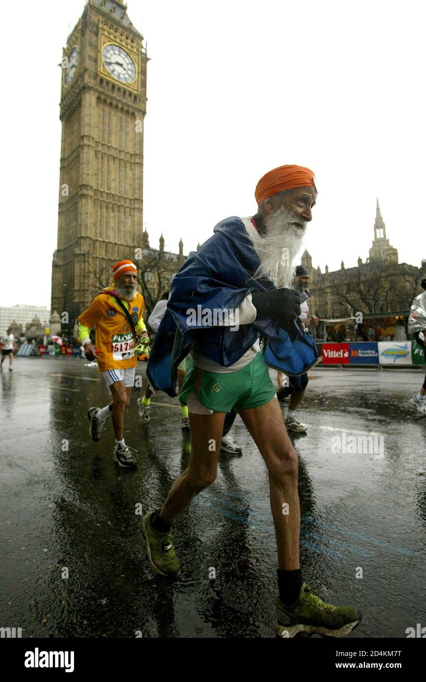 The oldest runner competing in the London marathon, 93-year-old Fauja  Singh, passes the Houses of Parliament, April 18, 2004 Stock Photo - Alamy