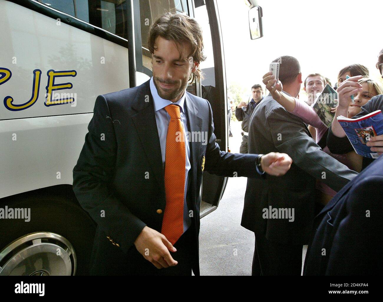 Dutch striker Ruud van Nistelrooy rushes past Macedonian fans after the team arrived at Macedonian capital Skopje, October 8, 2004. Macedonia will meet Netherlands on October 9 in their World Cup European zone Group one qualifying match. REUTERS/Ognen Teofilovski  OP Stock Photo
