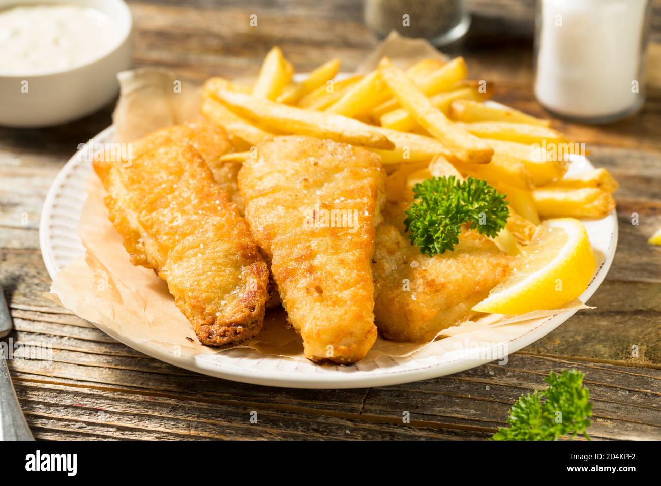 Homemade British Fish and Chips with Tartar and Lemon Stock Photo