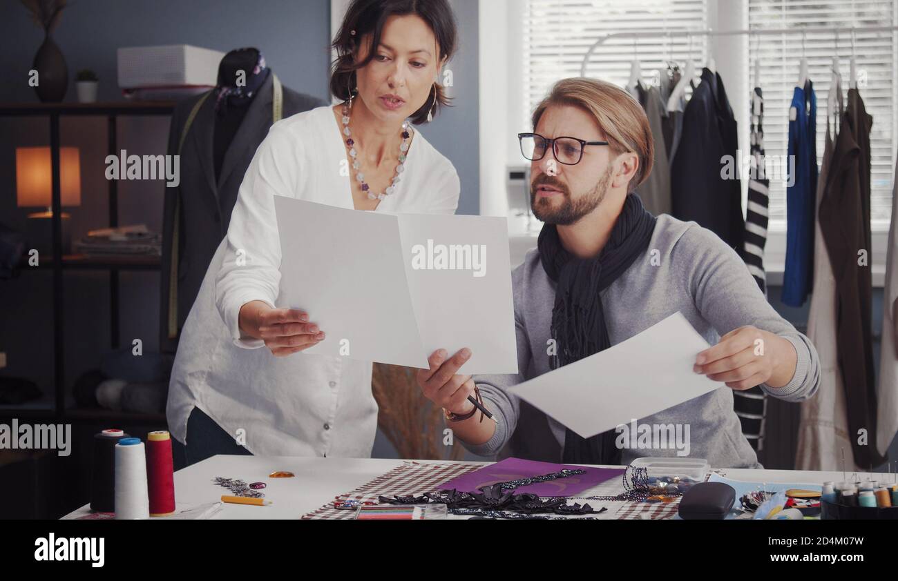 Two fashion designers comparing sketches Stock Photo