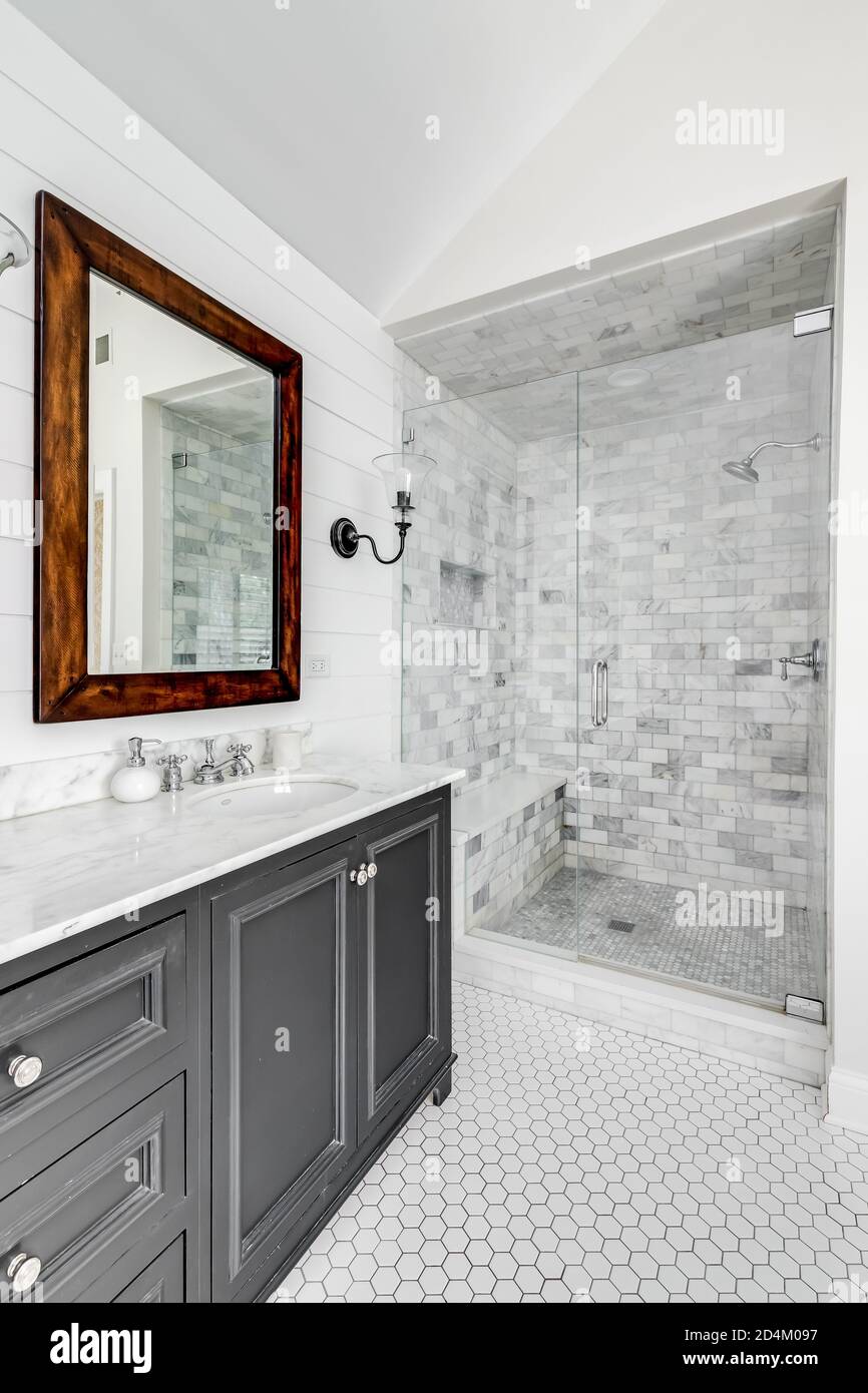 A Luxurious Renovated Bathroom With A Grey Vanity A Luxurious Renovated Bathroom With A Grey Vanity
