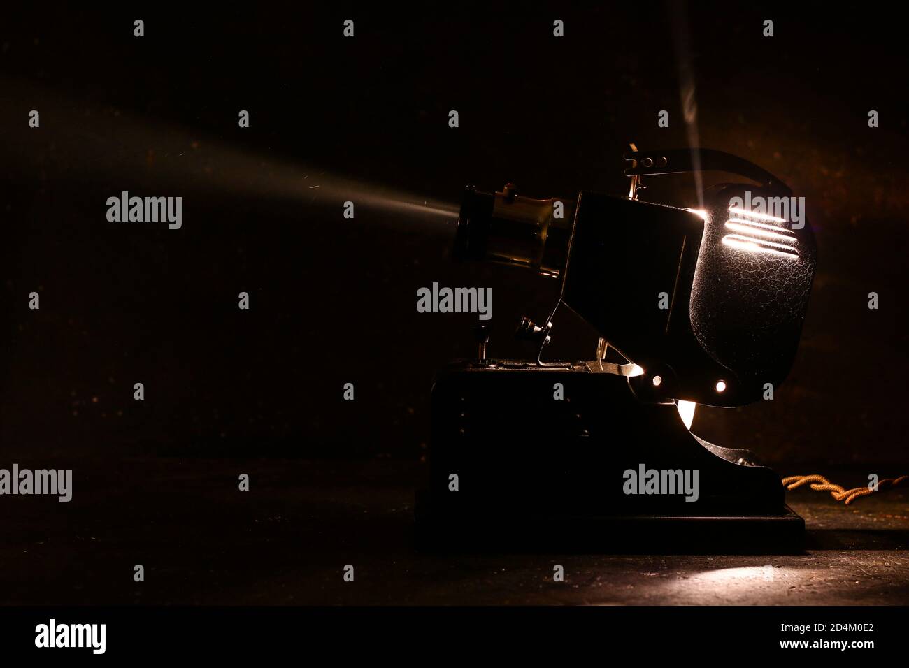 Old film projector, running and projecting with visible beam of light