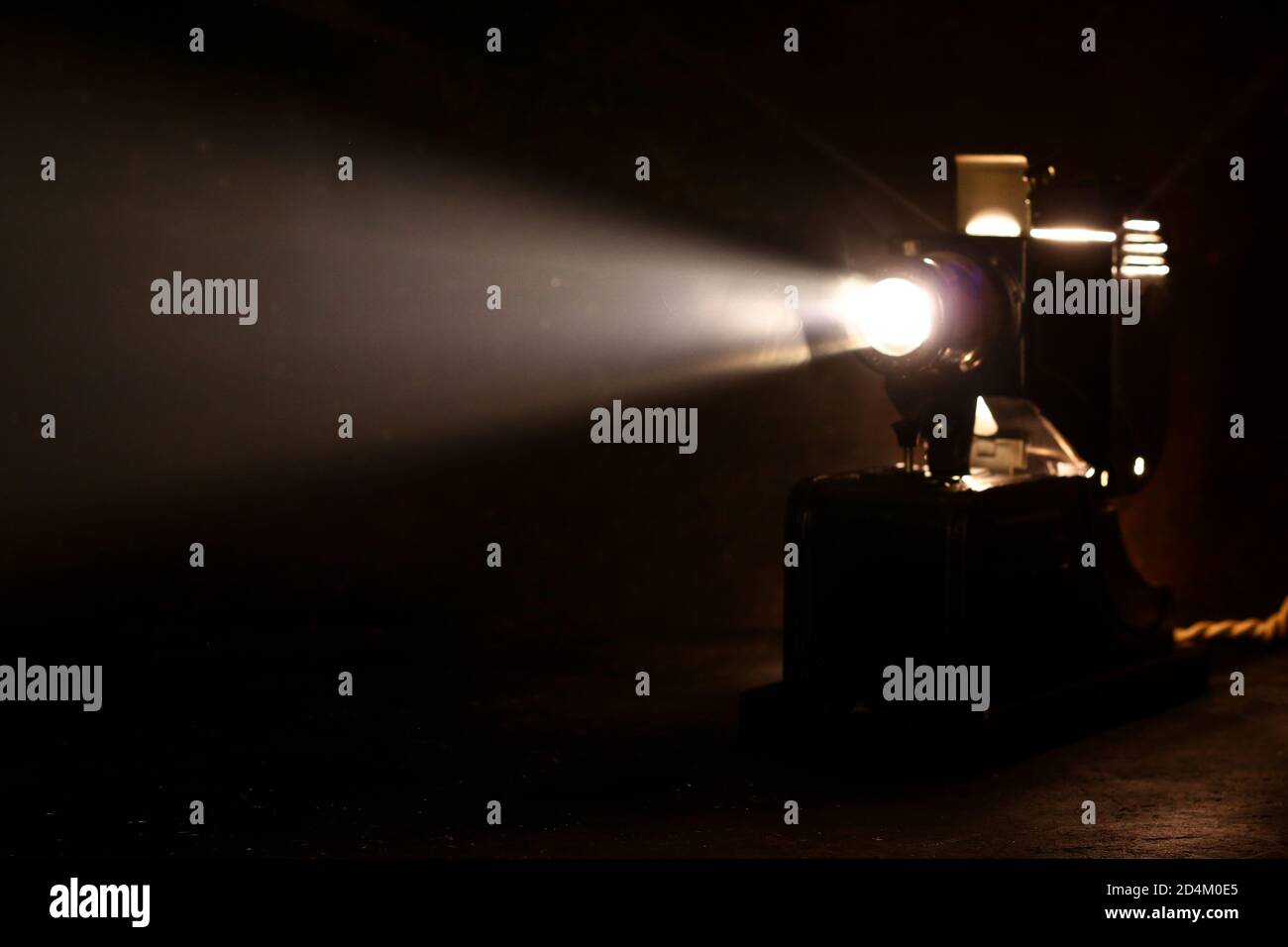 Old film projector, running and projecting with visible beam of light