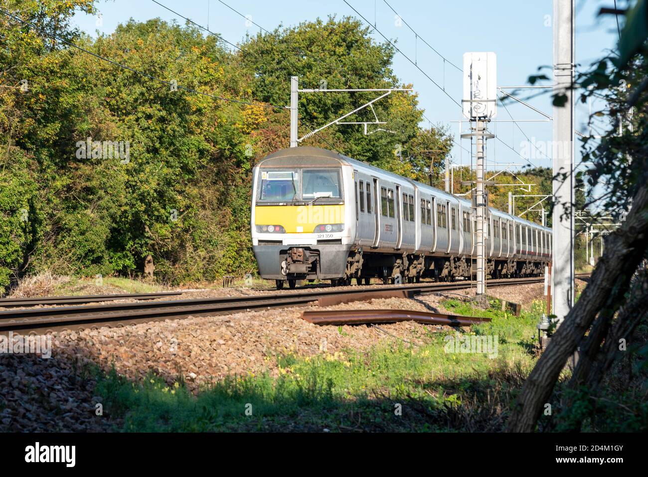 British Rail Class 321 alternating current (AC) electric multiple unit (EMU) Greater Anglia train passing Hawkwell, Rochford, near Southend, Essex, UK Stock Photo