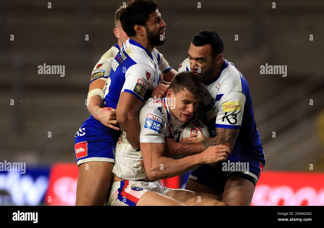 Wakefield Trinity's Alex Walker (centre) is tackled by St Helens' Dominique Peyroux (left) and Zeb Taia during the Betfred Super League match at Emerald Headingley Stadium, Leeds. Stock Photo
