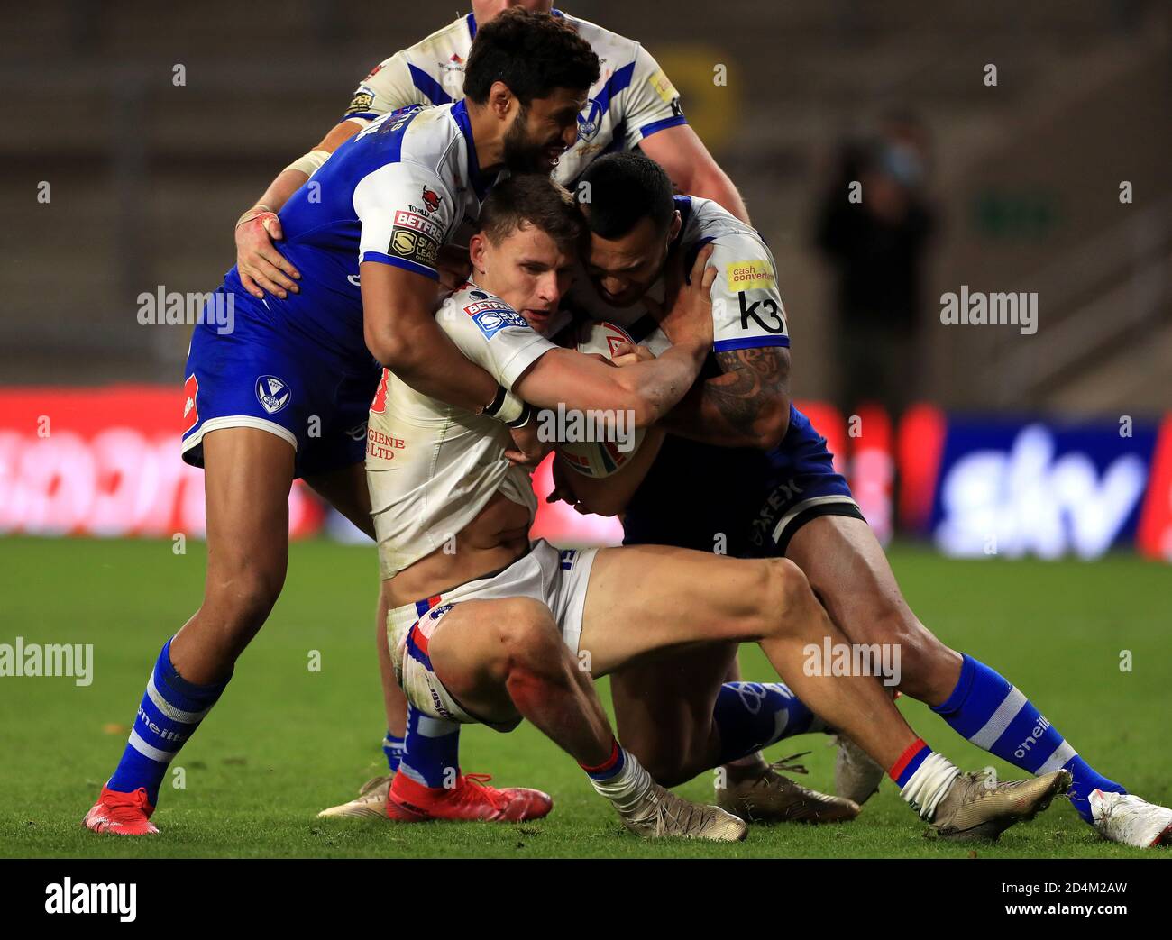 Wakefield Trinity's Alex Walker (centre) is tackled by St Helens' Dominique Peyroux (left) and Zeb Taia during the Betfred Super League match at Emerald Headingley Stadium, Leeds. Stock Photo