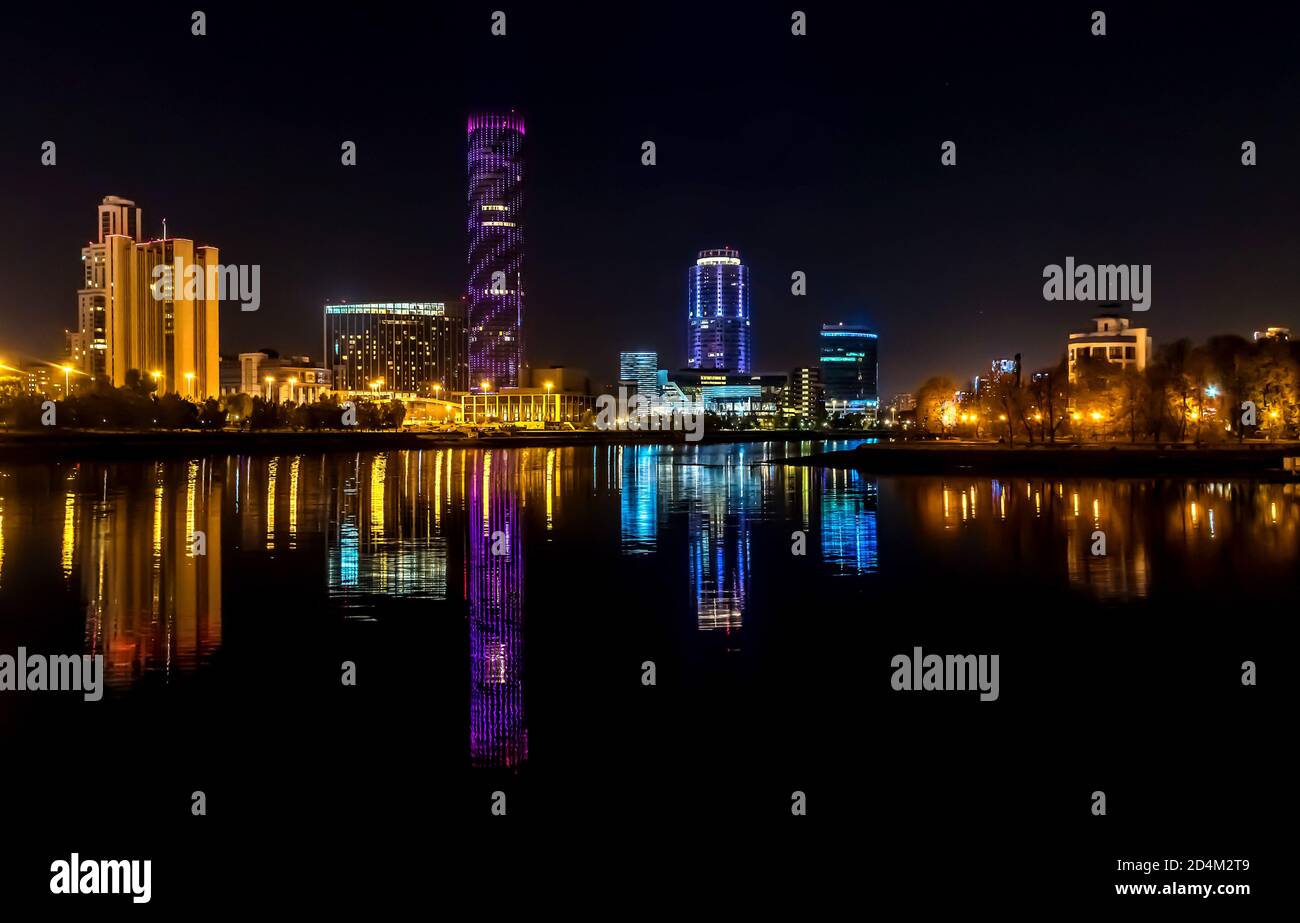 The lights of night city reflected in the river. Yekaterinburg, Russia Stock Photo