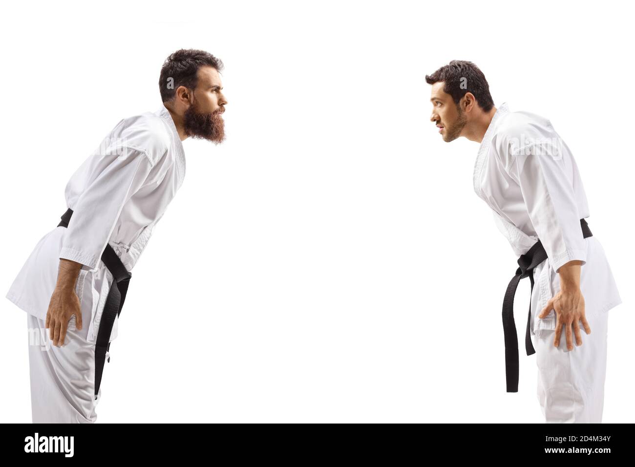 Men in karate kimonos bowing isolated on white background Stock Photo