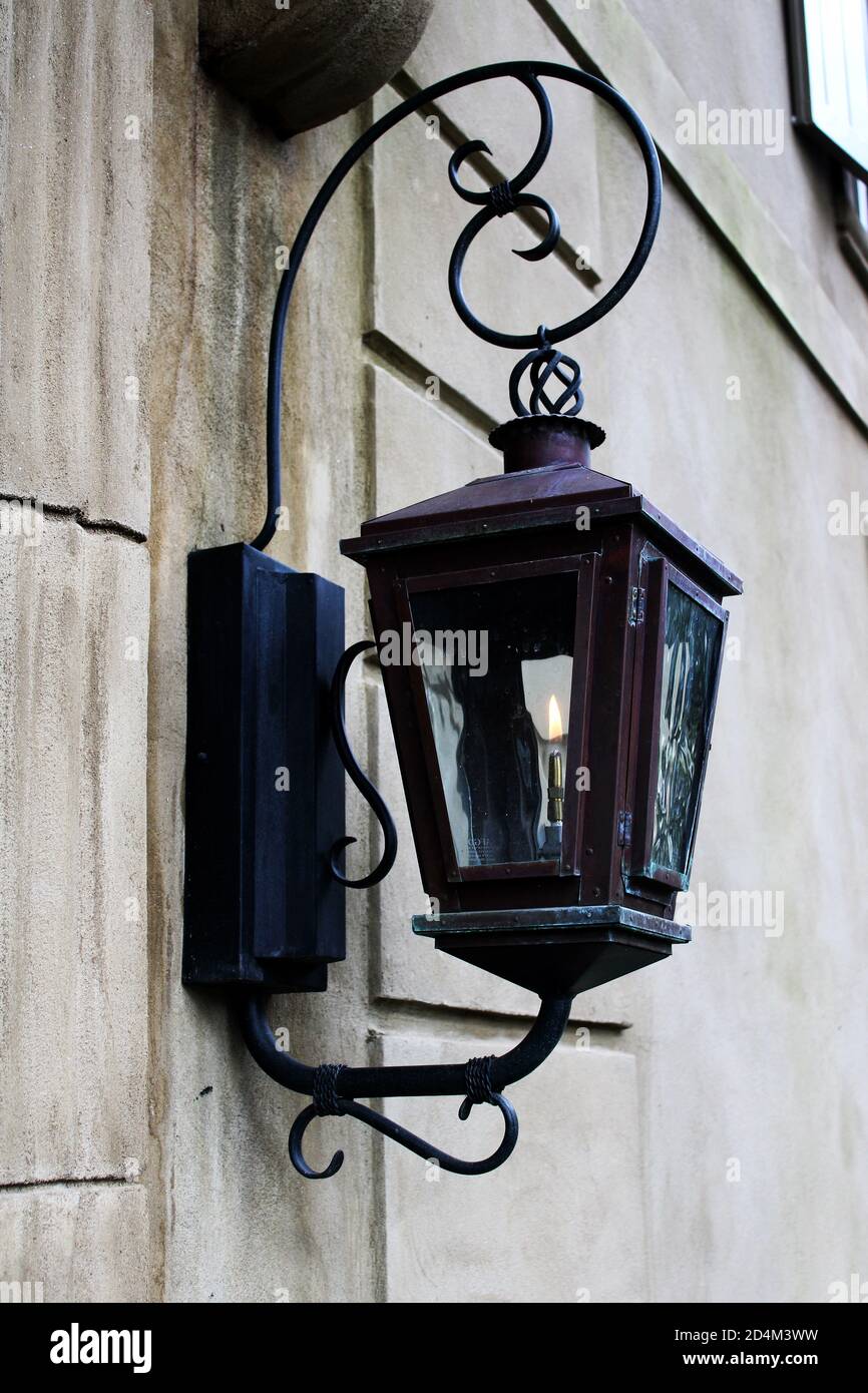 an elegant old-fashioned gas light lantern mounted on a weathered white  wall Stock Photo - Alamy