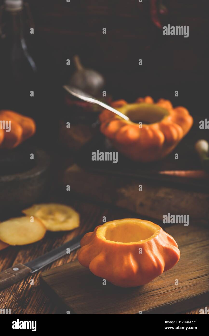 Preparing yellow pattypan squash for stuffing Stock Photo