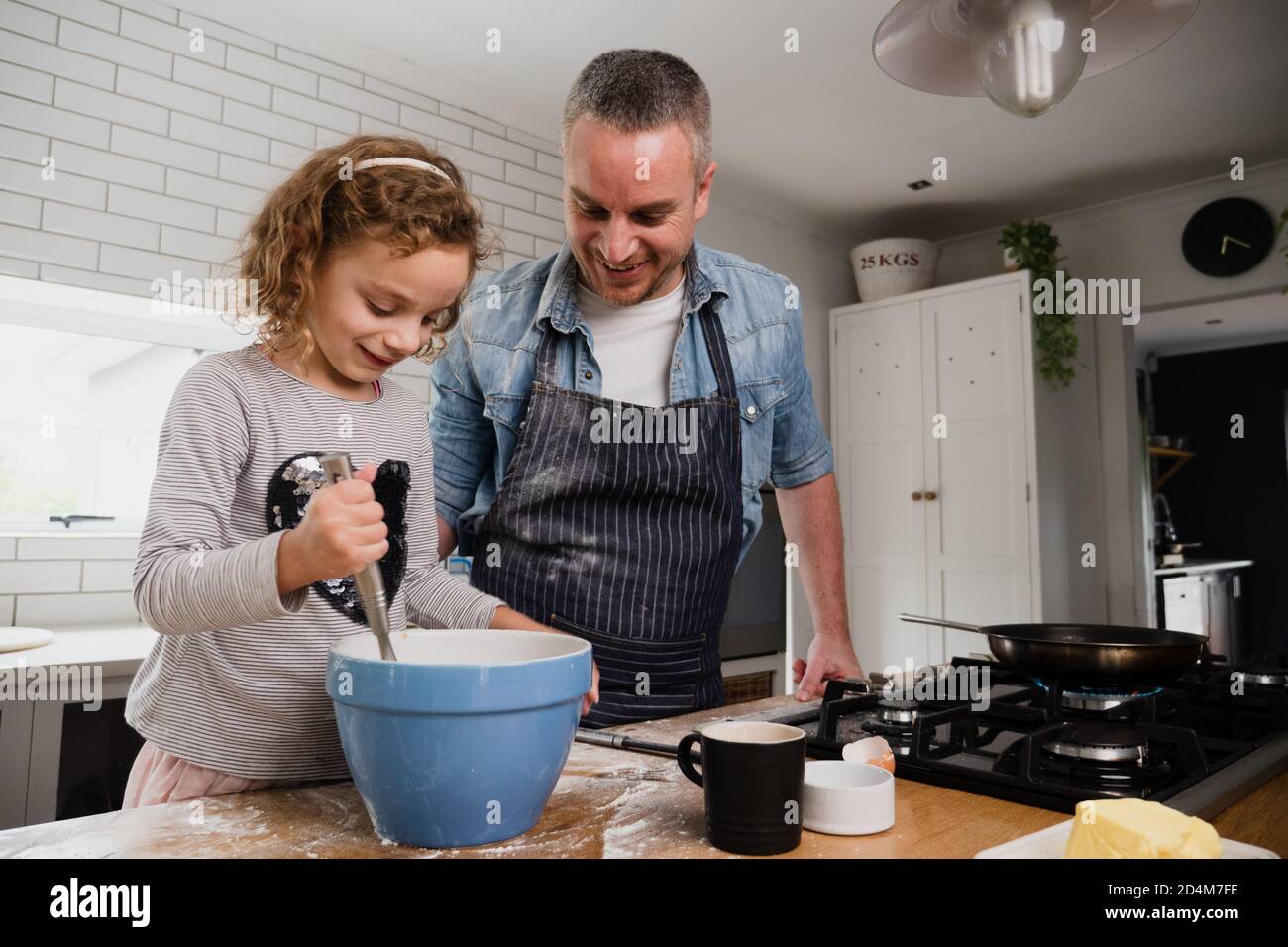caucasian-daughter-and-father-baking-together-in-the-kitchen-at-home-on
