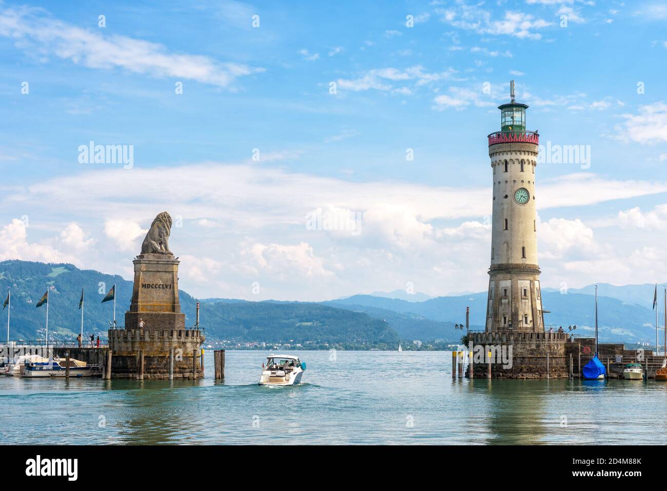 Harbor entrance at Lake Constance, Lindau, Germany. Beautiful landscape with lion statue and lighthouse. Scenic view of Constance or Bodensee in summe Stock Photo