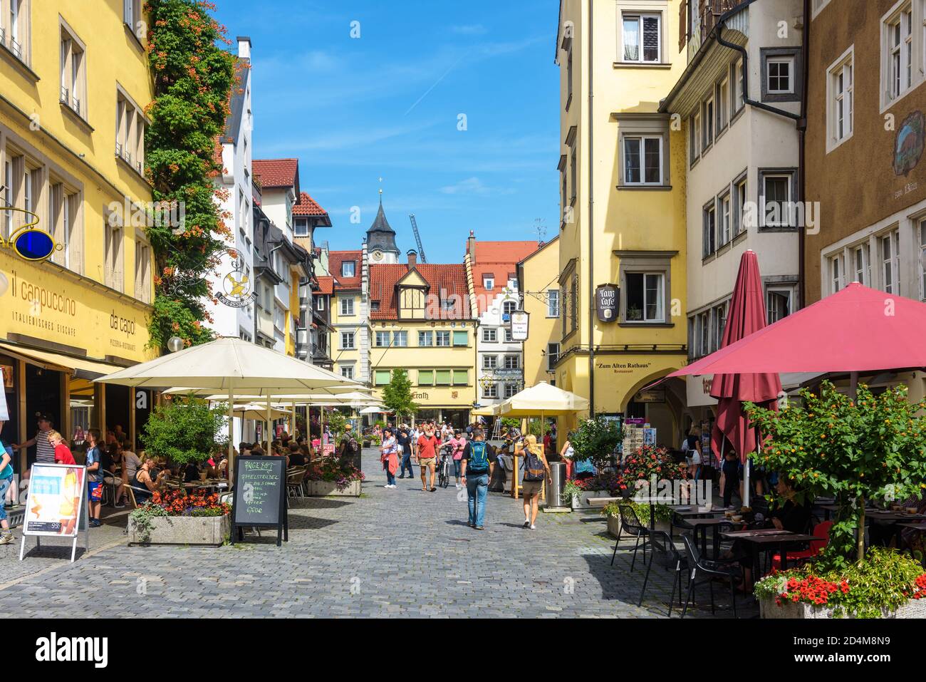 Lindau, Germany - July 19, 2019: Street in old town of Lindau, people walk next to shops, restaurants and cafes in summer. This city at Lake Constance Stock Photo