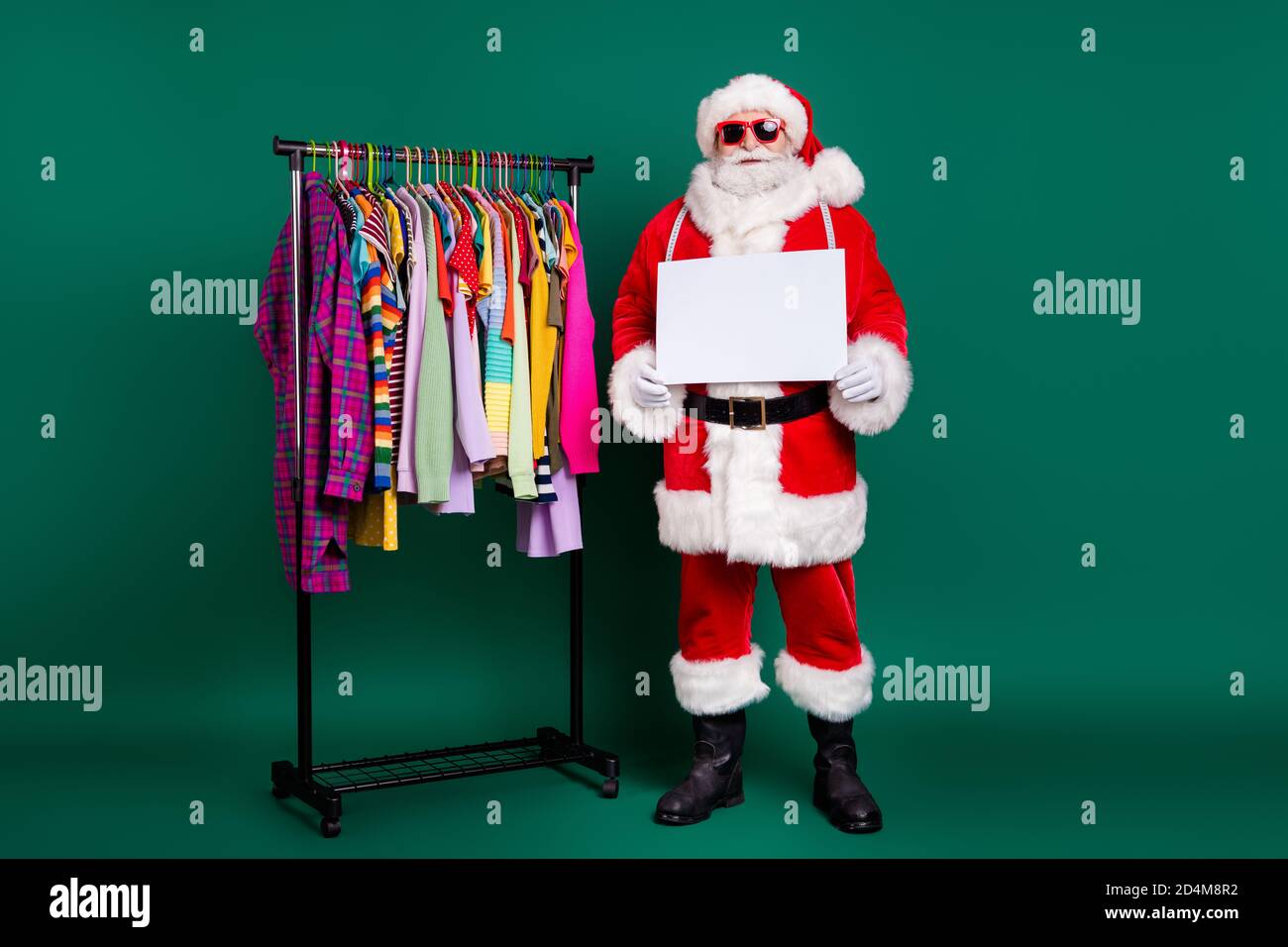 Full length body size view of his he nice fat funny bearded overweight Santa selling season clothes giving away outlet center holding in hands poster Stock Photo