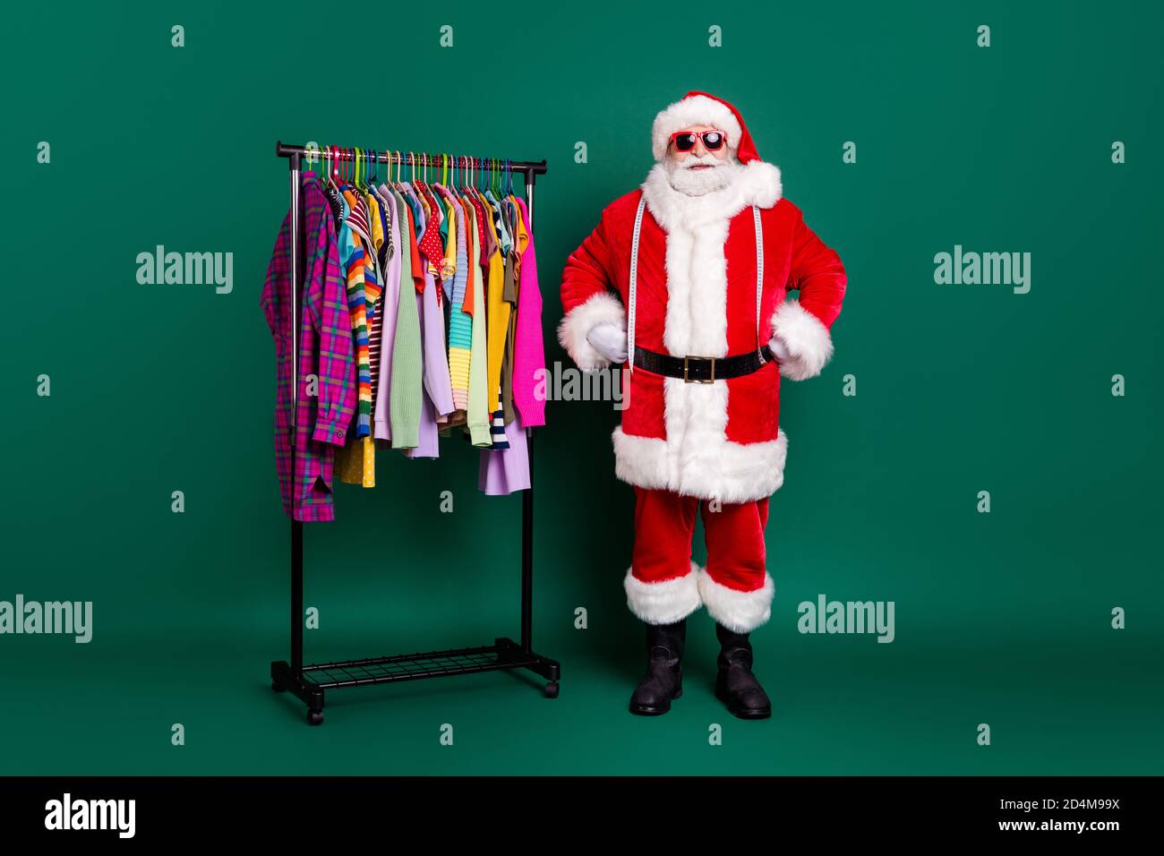 Full length photo funny funky santa claus x-mas shopping mall assistant  ready help choose assortment wardrobe garment wear costume cap headwear  boots Stock Photo - Alamy