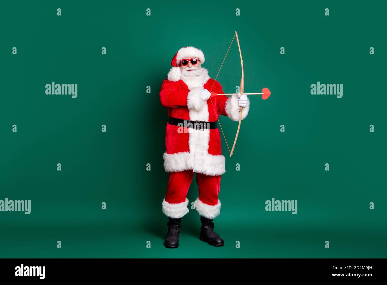 Full length profile photo of retired grandpa hold bow shoot arrow heart shape miss target make wrong couple wear red santa costume coat gloves Stock Photo