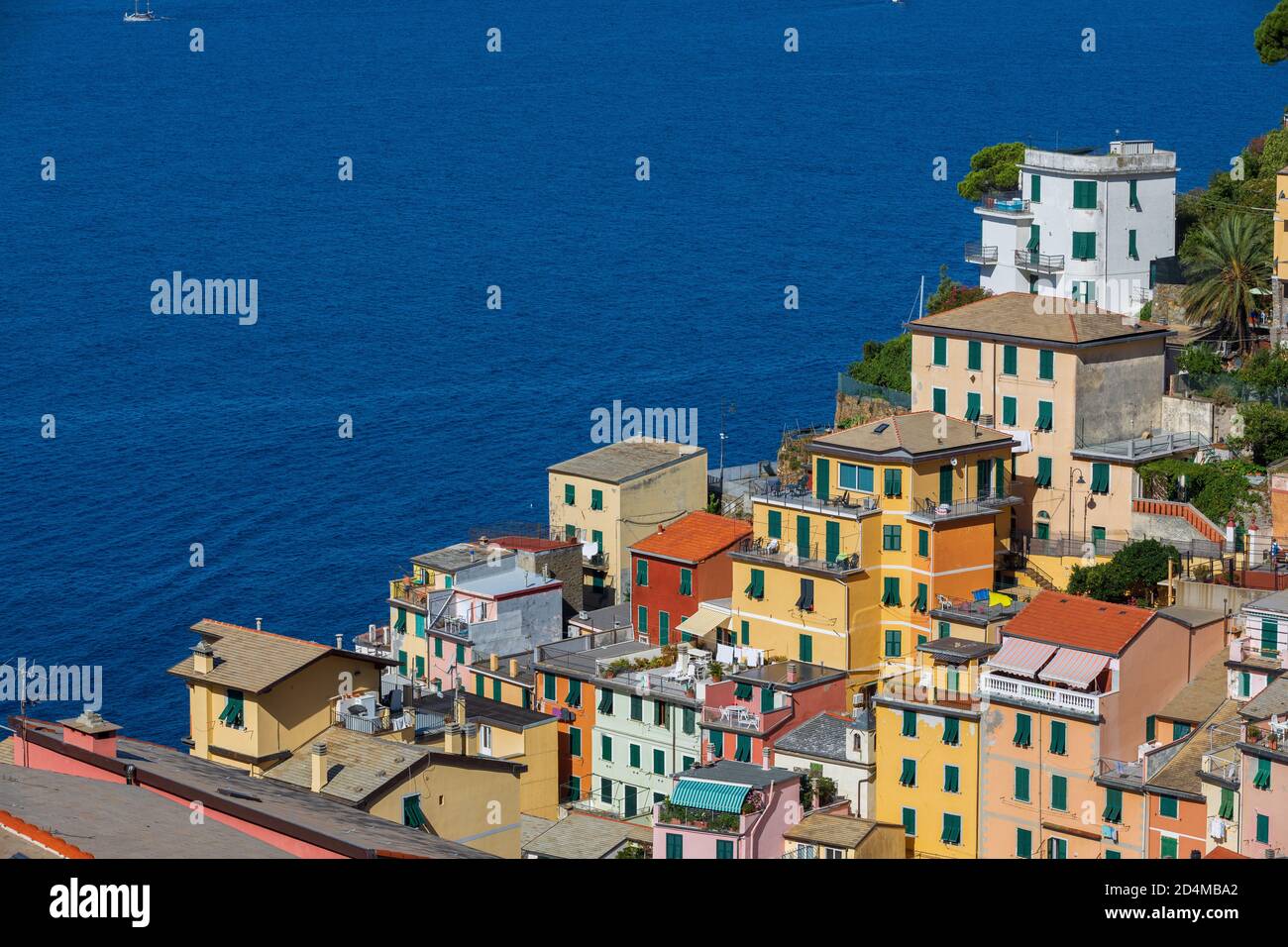 Ancient colorful village houses on the open sea. Location: city of Riomaggiore in the Italian region of Liguria. Perched buildings. Stock Photo