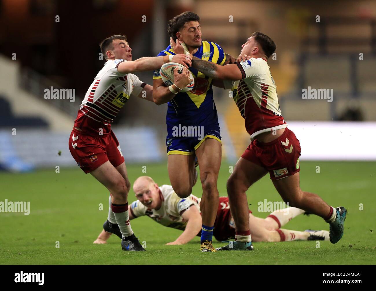 Warrington Wolves' Anthony Gelling (centre) is tackled by Wigan Warriors' Oliver Partington (left) and Harry Smith as Liam Farrell looks on during the Betfred Super League match at Emerald Headingley Stadium, Leeds. Stock Photo