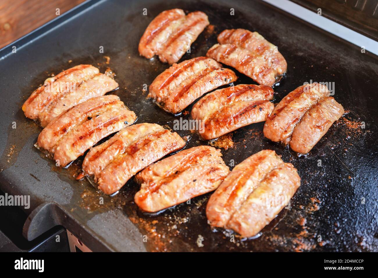 Small bratwurst / hot dog frankfurter sausages grilled on electric