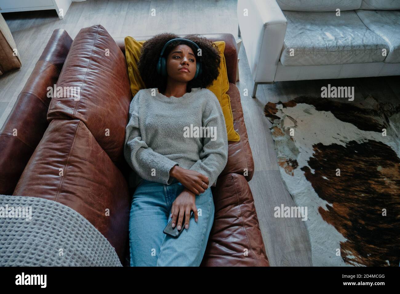 Woman lying on leather couch hi res stock photography and images