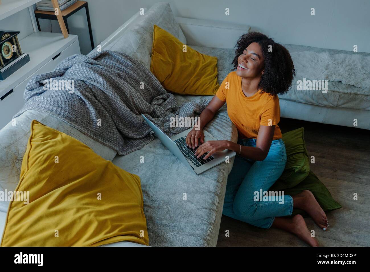 african american lady working on computer and laughing. Stock Photo