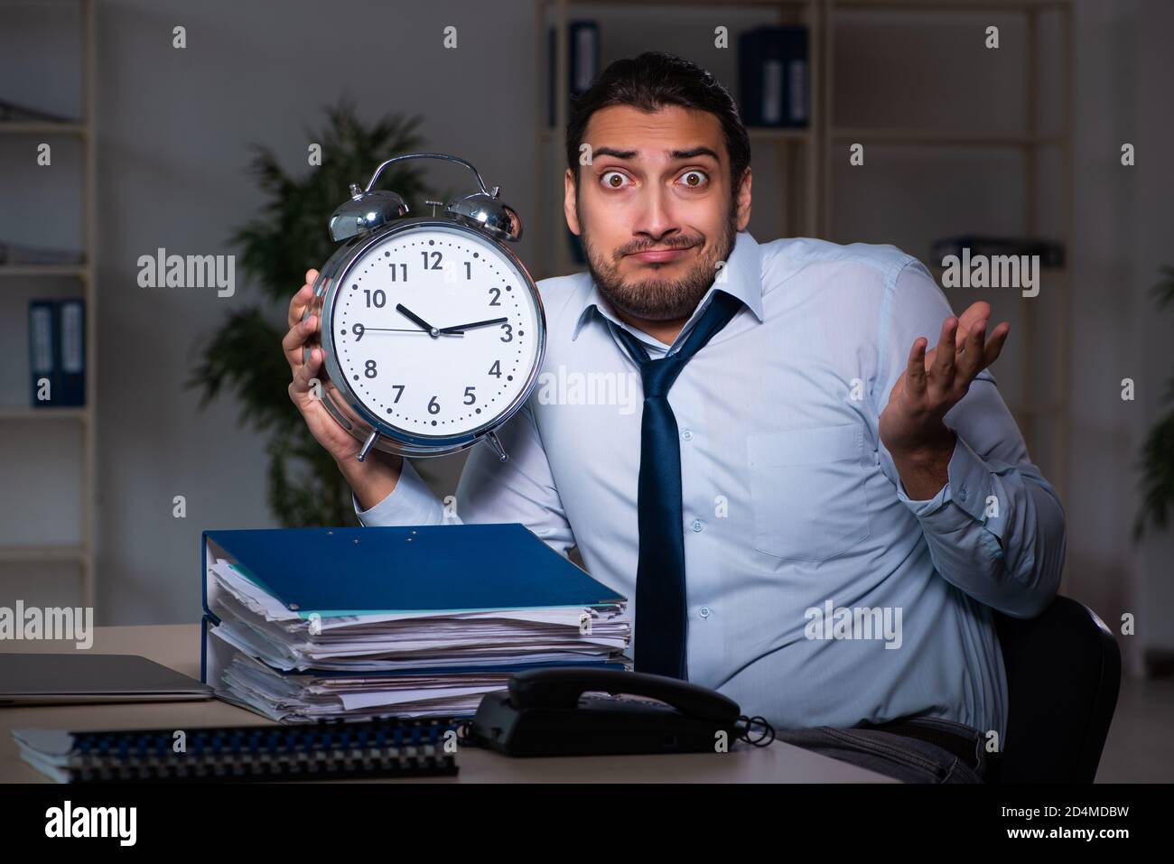 Young businessman working late in the office workplace Stock Photo - Alamy