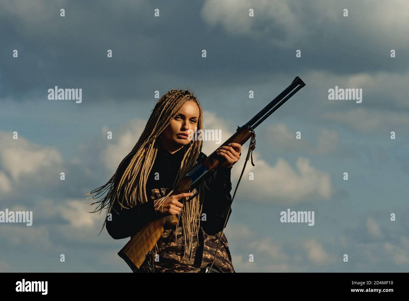 Hunter girl. Hunting in America. Young hunter woman holding gun and