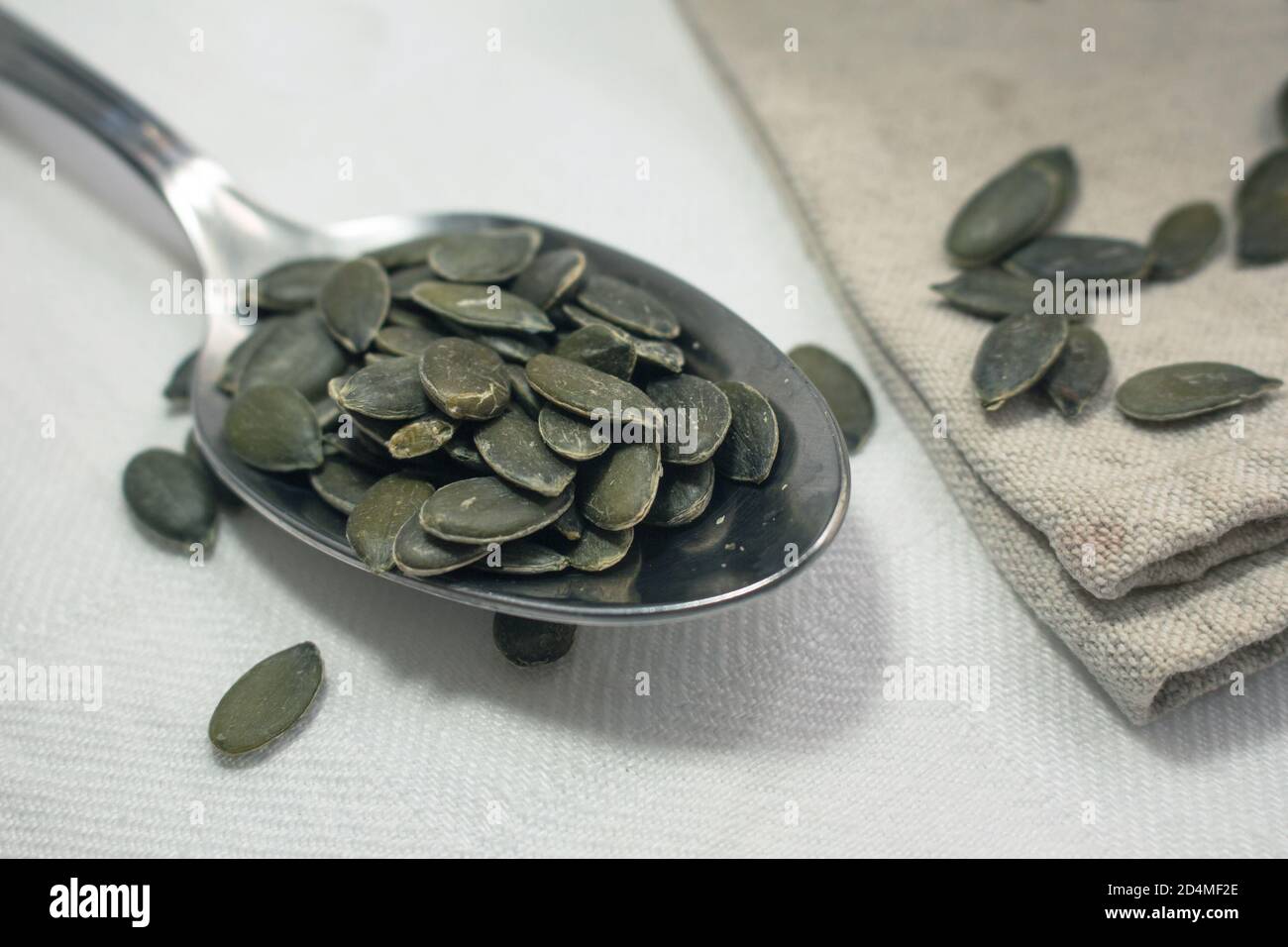 Detail of a spoon full of pumpkin seeds Stock Photo