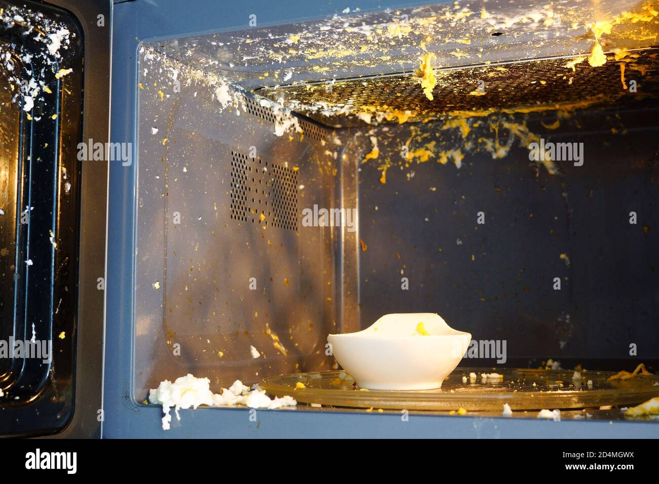 Incorrectly cooked egg in the microwave. The egg exploded Stock Photo