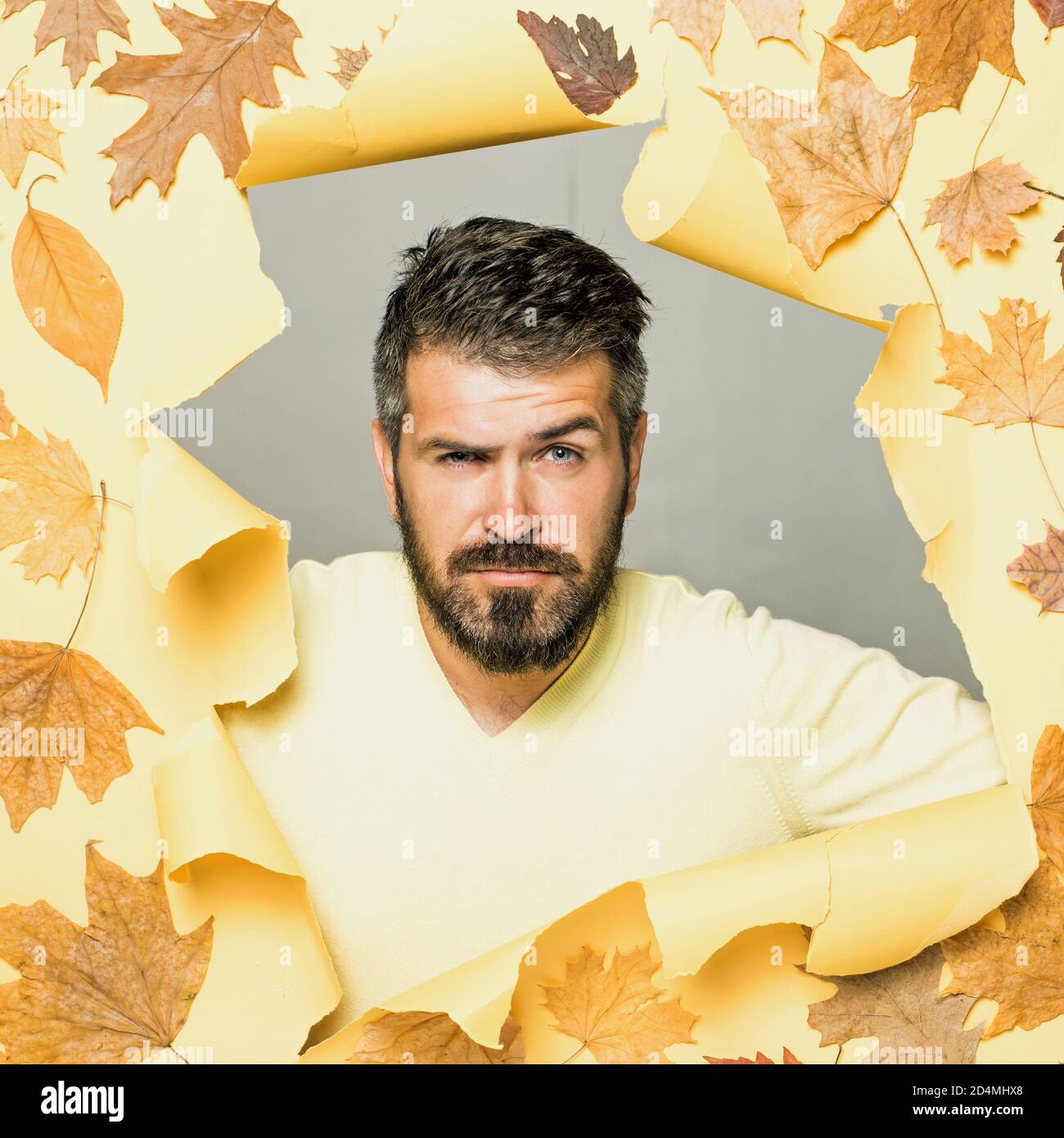 Cheerful man rejoices in autumn sales. Attractive young man in