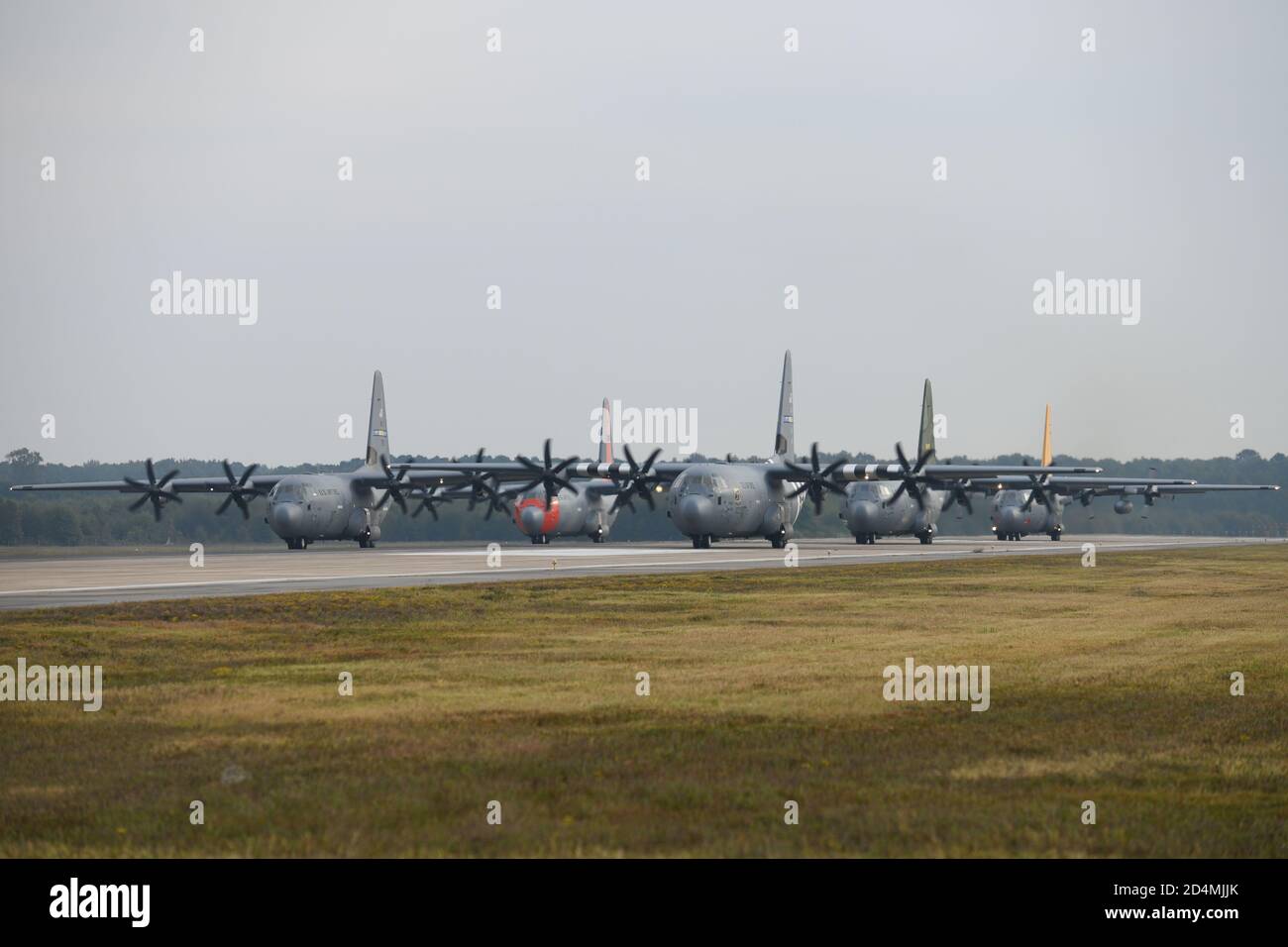 C-130s taxi on the flight line in celebration of the 65th anniversary of the base’s first open house at Little Rock Air Force Base, Arkansas, Oct. 8, 2020. The display of heritage aircraft honored local Arkansans for their unwavering support since 1955. (U.S. Air Force photo by Airman 1st Class Mariam K. Springs) Stock Photo