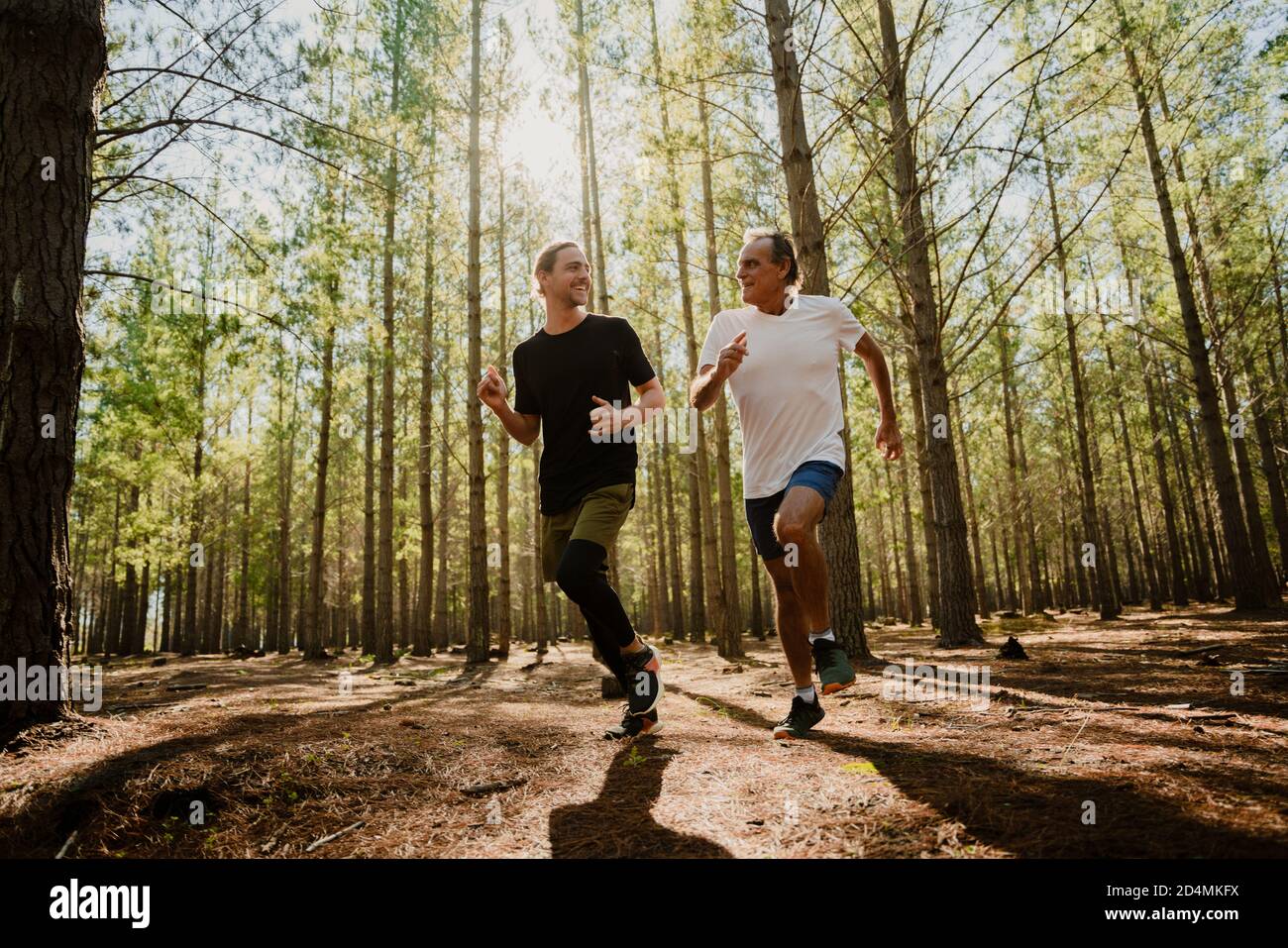 Father and son running in the woods together exercising and keeping fit Stock Photo Alamy