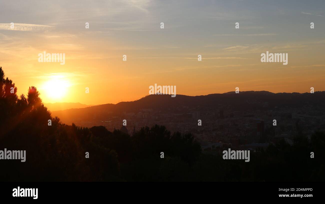 Beautiful sunset over the forest and the mountains Stock Photo - Alamy