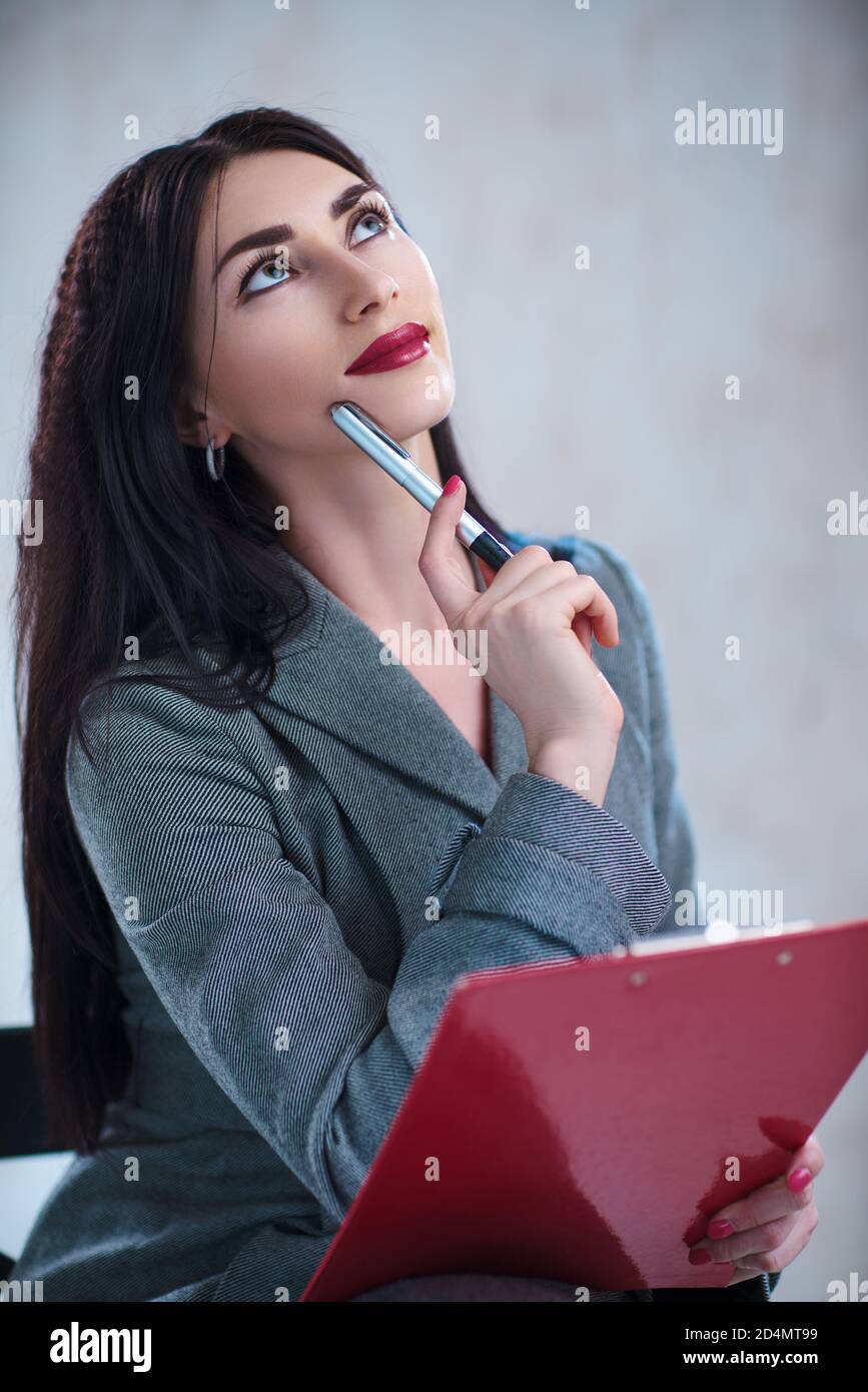 Woman thinking with pen pencil hi-res stock photography and images - Alamy