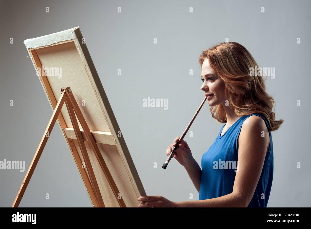 Woman artist with brush paint on easel art hobby light background Stock ...