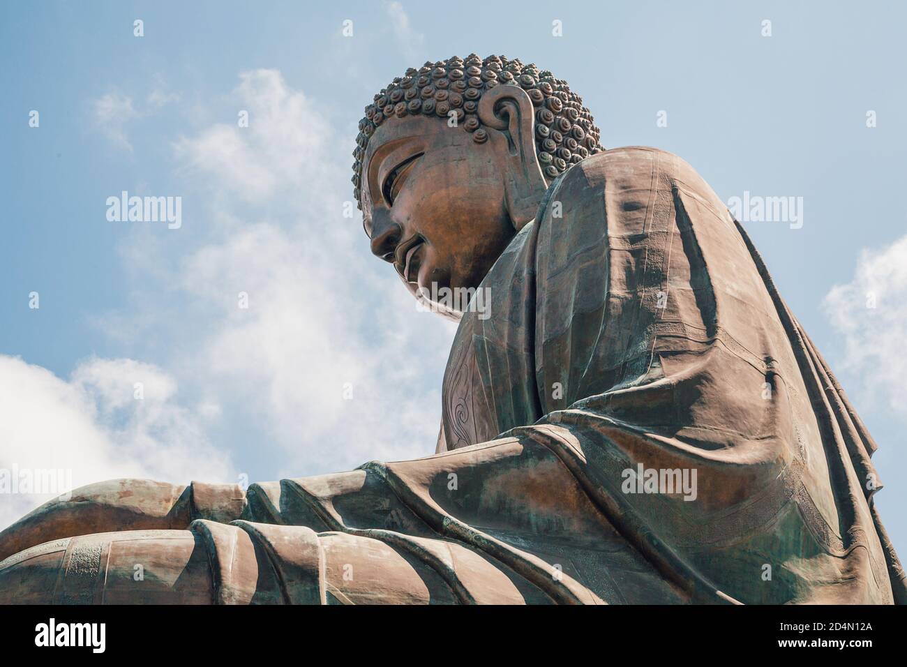 Big Buddha bronze statue under the cloudy sky in Hong Kong Stock Photo