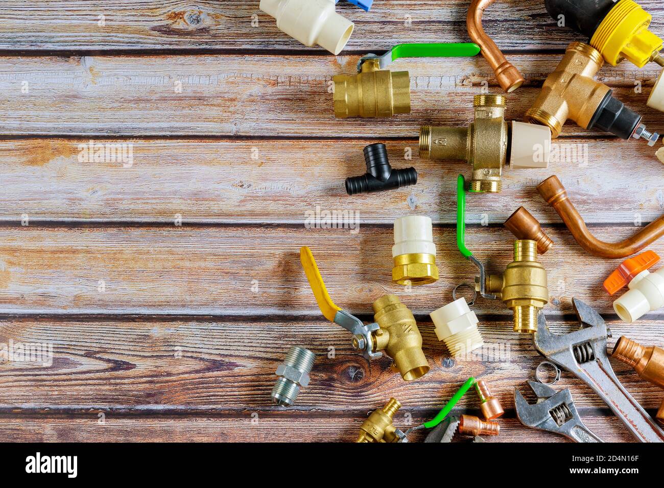 Brass diverter used on shower and bathtub with copper fitting and pipes set of tools for the plumbing in the work pipe cutting tools, fixings Stock Photo