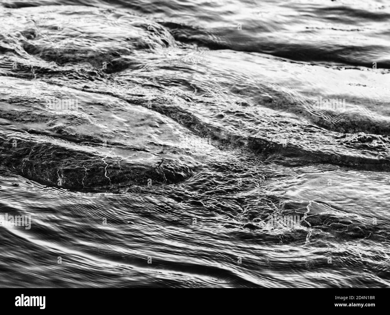 Monochrome ripples in seawater Stock Photo