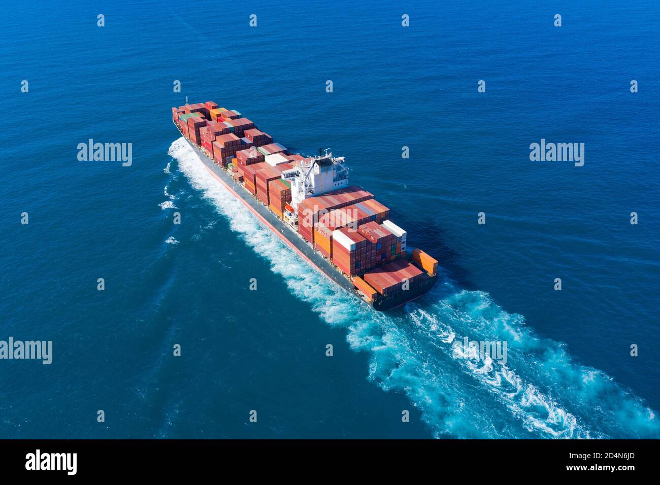Zim Tarragona loaded Container ship cruising away from port, Aerial view. Stock Photo