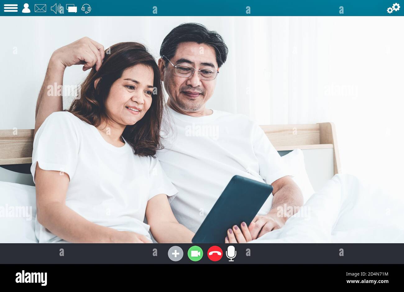 Happy senior people talking on internet video call at home while laughing with love . Online technology for mature parents . Webcam application in Stock Photo