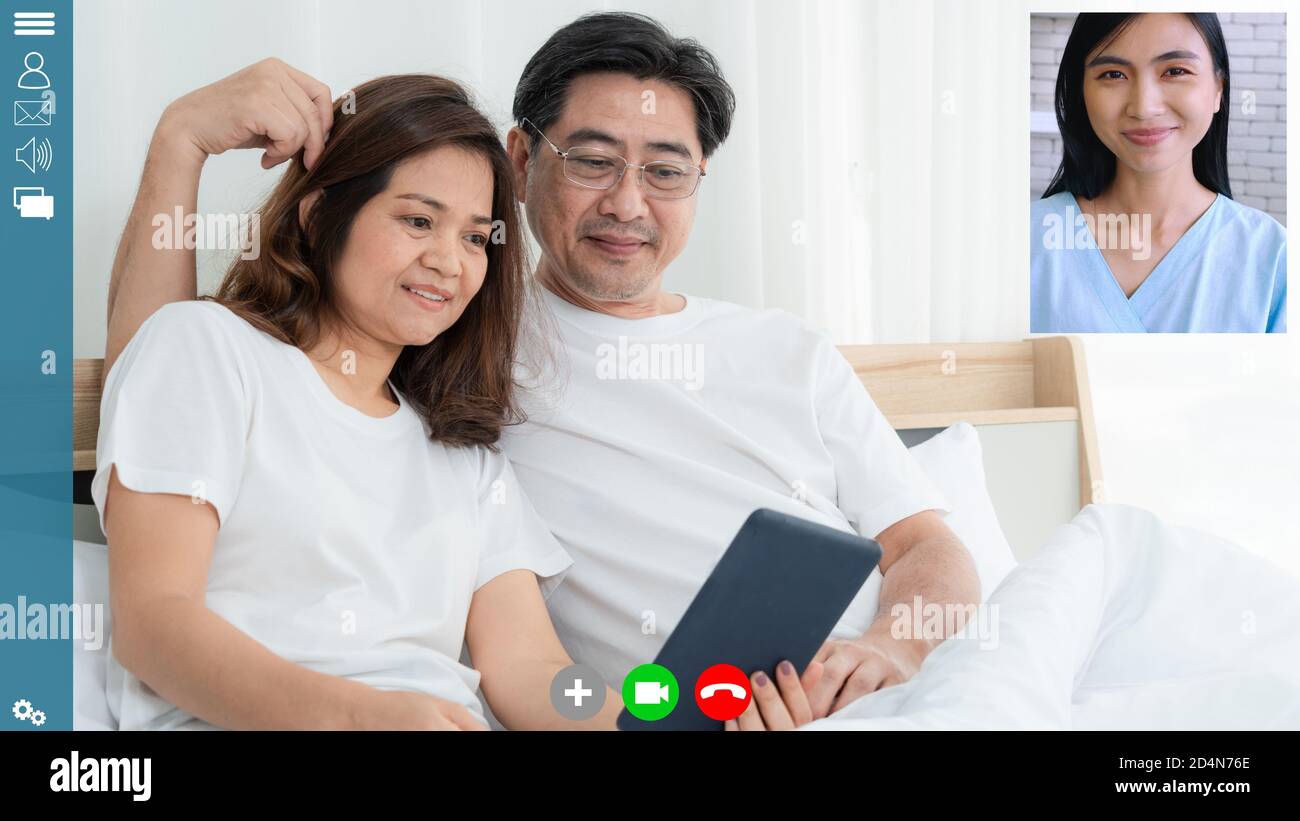 Happy family talking on internet video call at home while laughing with love . Online technology for mature parents . Webcam application in cropped Stock Photo